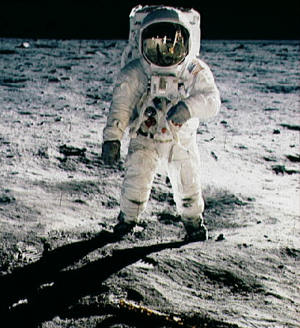 Astronaut Edwin ("Buzz") Aldrin on the Moon. The visor in his helmet shows a reflection of astronaut Neil Armstrong taking this picture, as well as one footpad of the Lunar Module Eagle and the United States flag planted next to it.